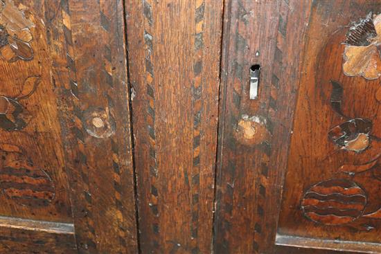 A 17th century marquetry inlaid oak court cabinet W.127cm